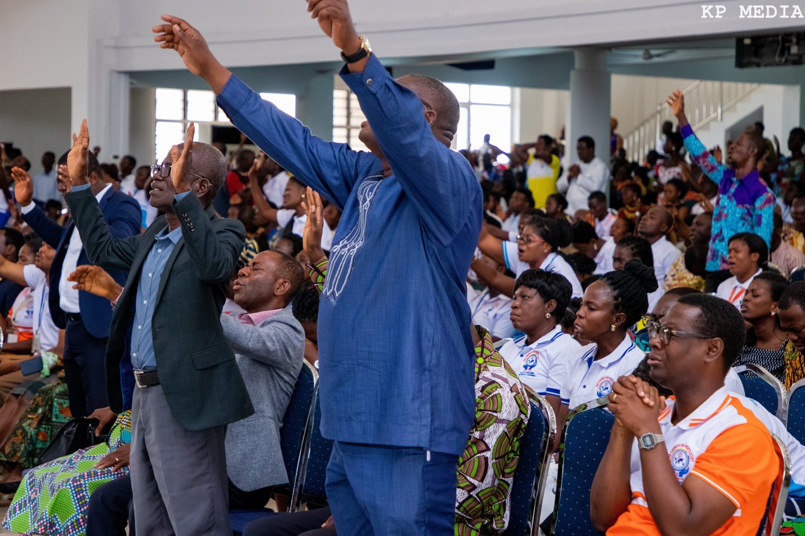 Pentecost workers worshipping together during a large Church gathering